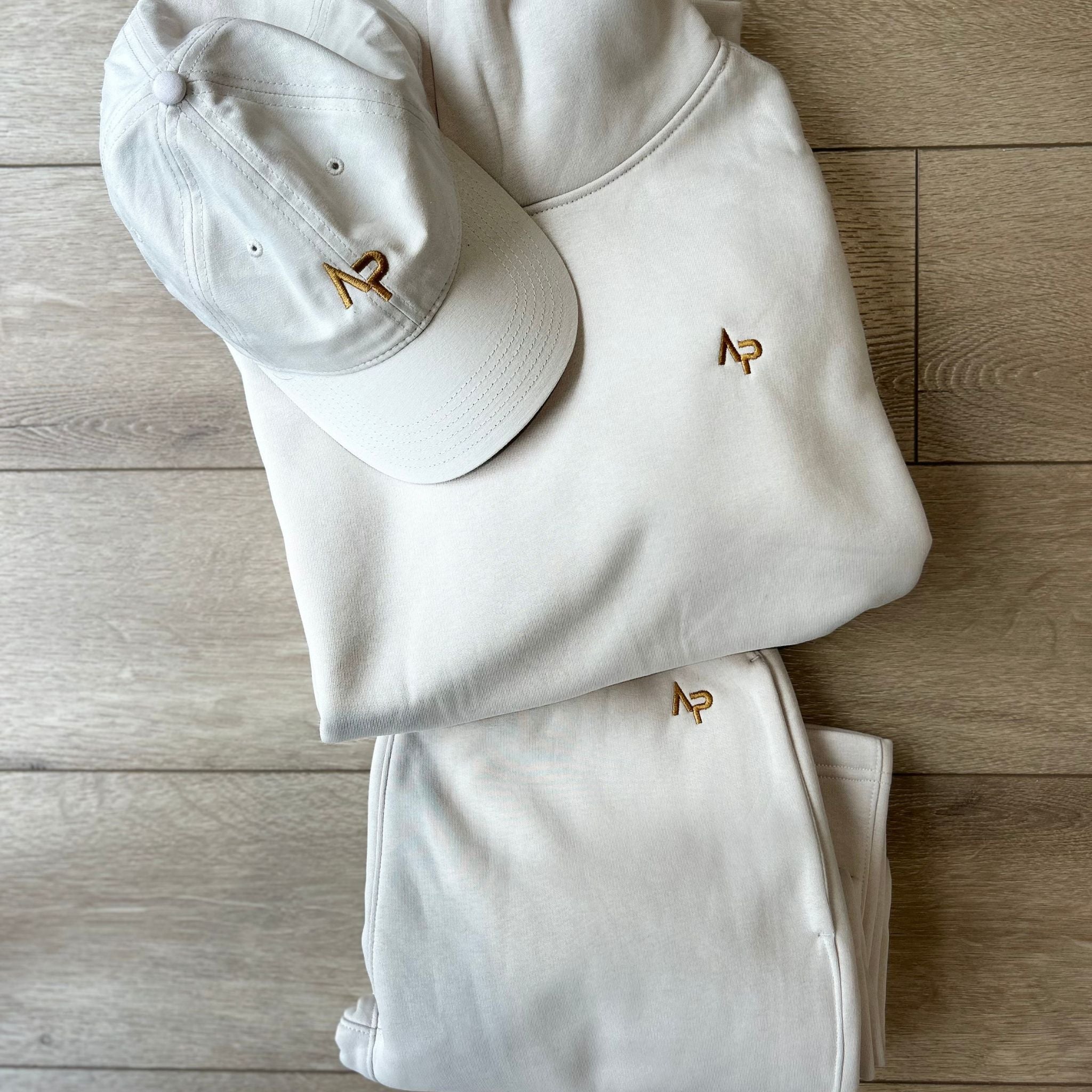 Angry Penguins | AP Bone Cotton Cap with gold logo with track pants and hoodie - Lifestyle